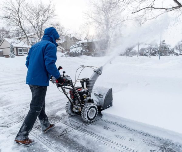Man Clearing Snow with a Snow Blower